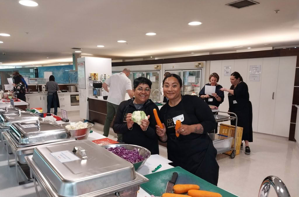 Volunteer group helping at a cook night in the main kitchen at Domain House